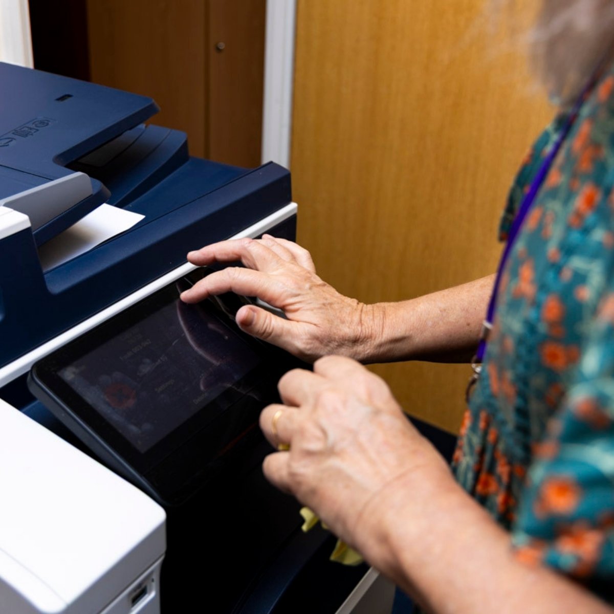 A bureau volunteer operating the photocopier