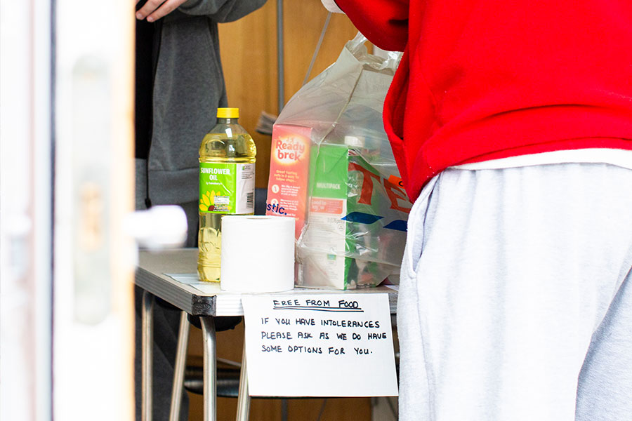 A local resident collecting their food parcel from the Friday Food Bank