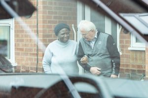 A Volunteer Driver helping a local resident from her door to the car