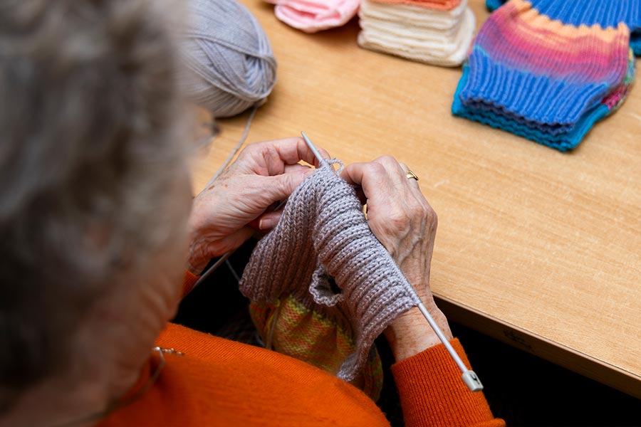 One of our local residents knitting in one of our meeting spaces at the bureau