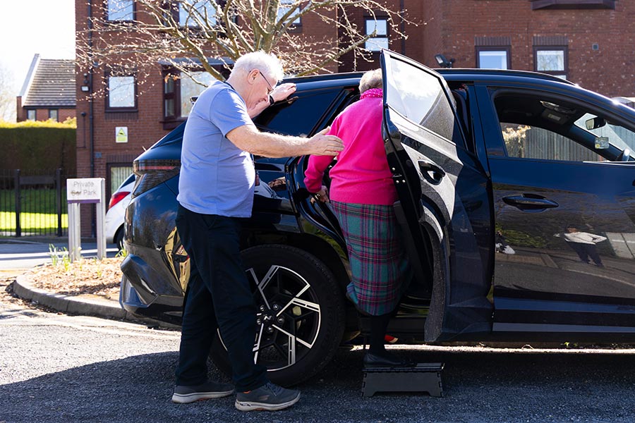 A Volunteer Driver helping a local resident into the car