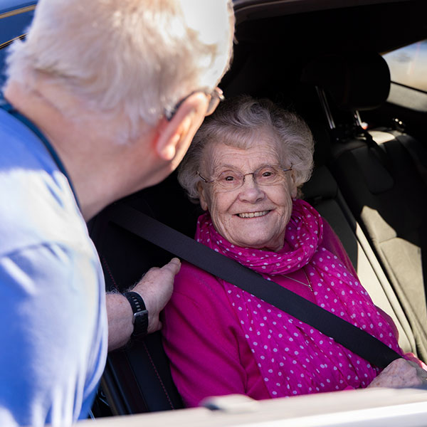 One of our Volunteer Drivers chatting to a local resident and user of our Transport Scheme